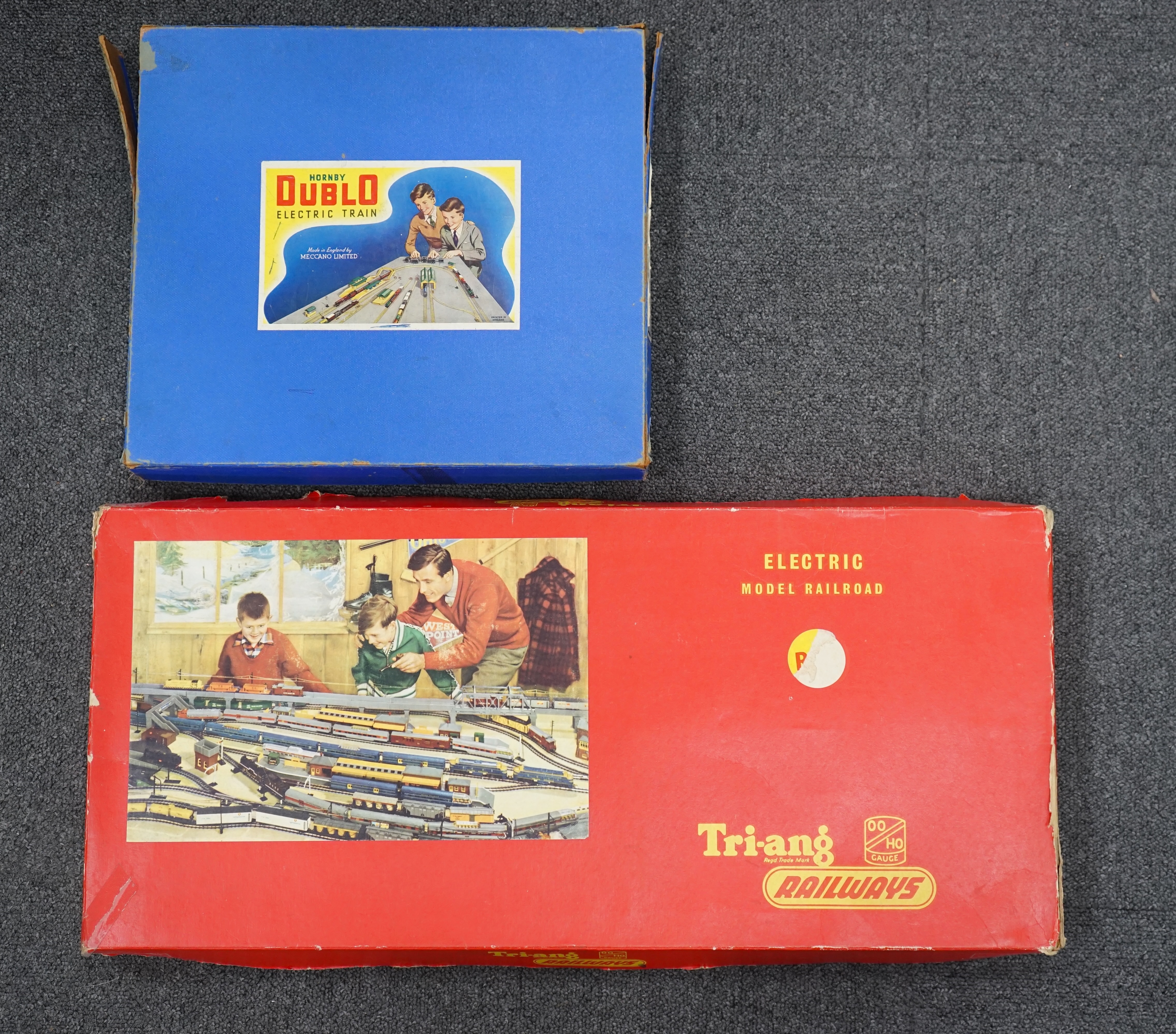 A collection of Hornby Dublo and Tri-ang Railways 00 gauge railway contained within two original boxes; a Hornby Dublo EDG17 Tank Goods Train B.R. set, contents include a BR Standard Class 4, 80054, fourteen tinplate fre